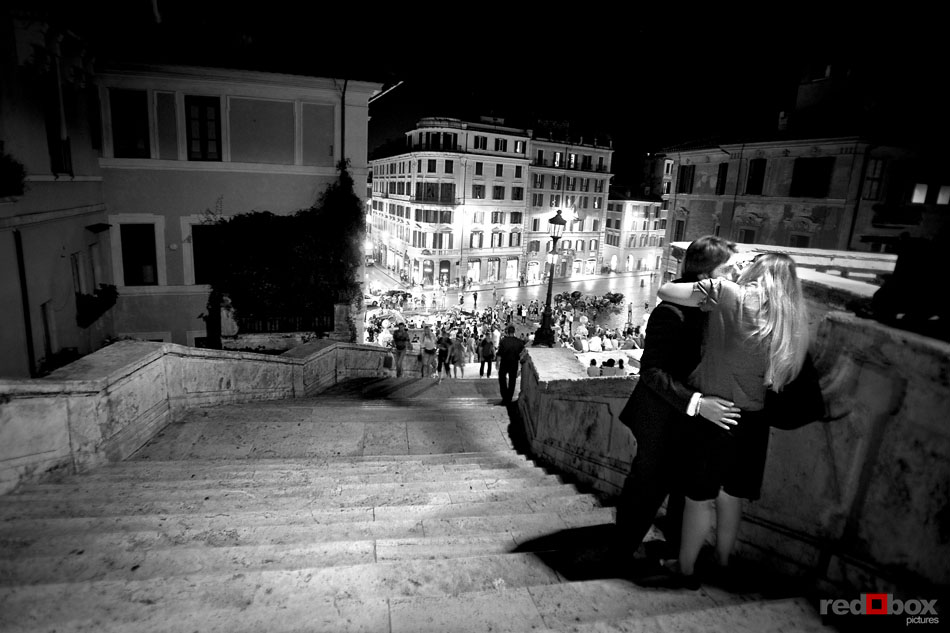 A couple kisses at the top of the Spanish Steps in Rome on a Friday night. (Italy photography by Scott Eklund/Red Box Pictures)