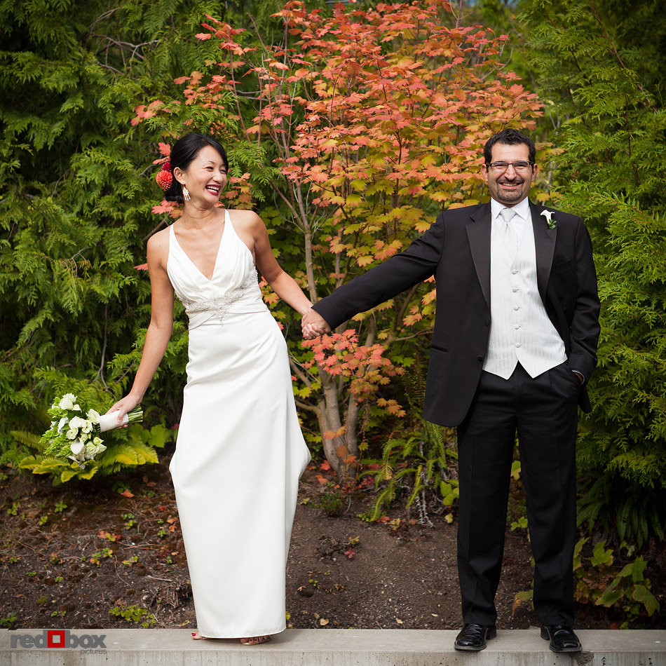 Jane and Kia portrait in front of the fall foliage at the Olympic Sculpture Park prior to their wedding at Velocity Dance Center in Seattle. (Photo by Andy Rogers/Red Box Pictures)