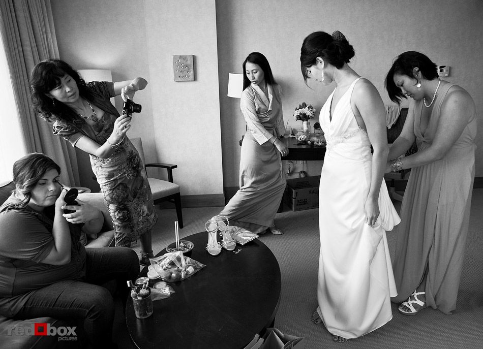Jane has her wedding dress bustled at The Pan Pacific Hotel prior to her wedding at Velocity Dance Center in Seattle. (Photo by Andy Rogers/Red Box Pictures)