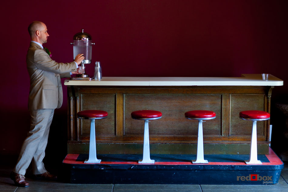 The groom gets a glass of water at the bar before his wedding ceremony at The Hall at Fauntleroy in West Seattle, WA. (Seattle Wedding Photography by Scott Eklund/Red Box Pictures)