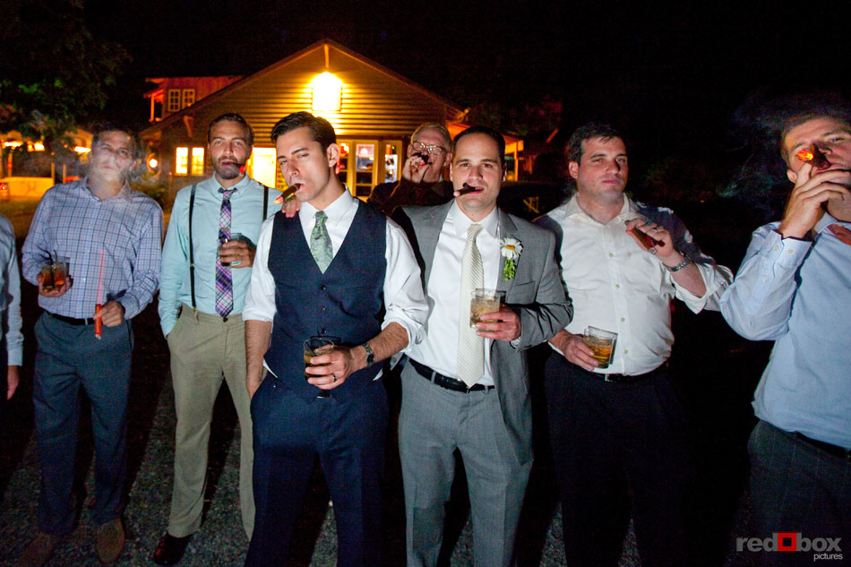 The groom and his buddies fire up the cigars during the wedding reception at Treehouse Point in Issaquah, Wash. (Seattle Wedding Photography Scott Eklund/Red Box Pictures)