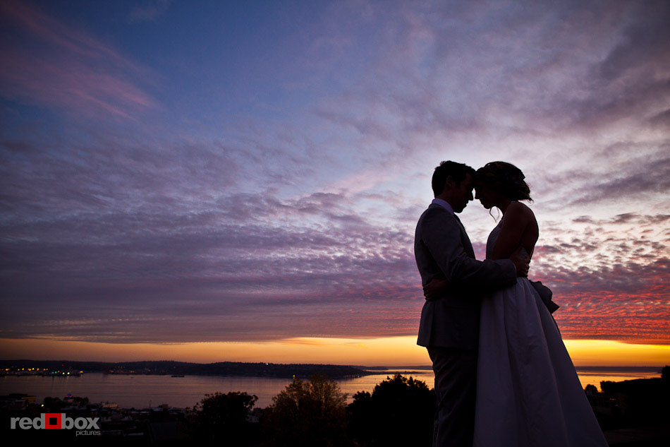 Jed and Amanda are silhouetted in front a beautiful sunset at Kerry Park viewpoint. They later married at Urban Lights Studio in Greenwood.  (Photo by Dan DeLong/Red Box Pictures)