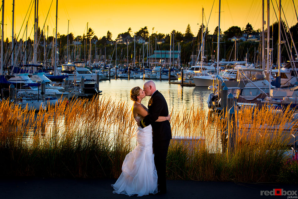 Jennifer & Lincoln enjoy the sunset and a kiss at their wedding at Tom Glenn Common in Bellingham, Washington. (Wedding Photography By Scott Eklund - Red Box Pictures)