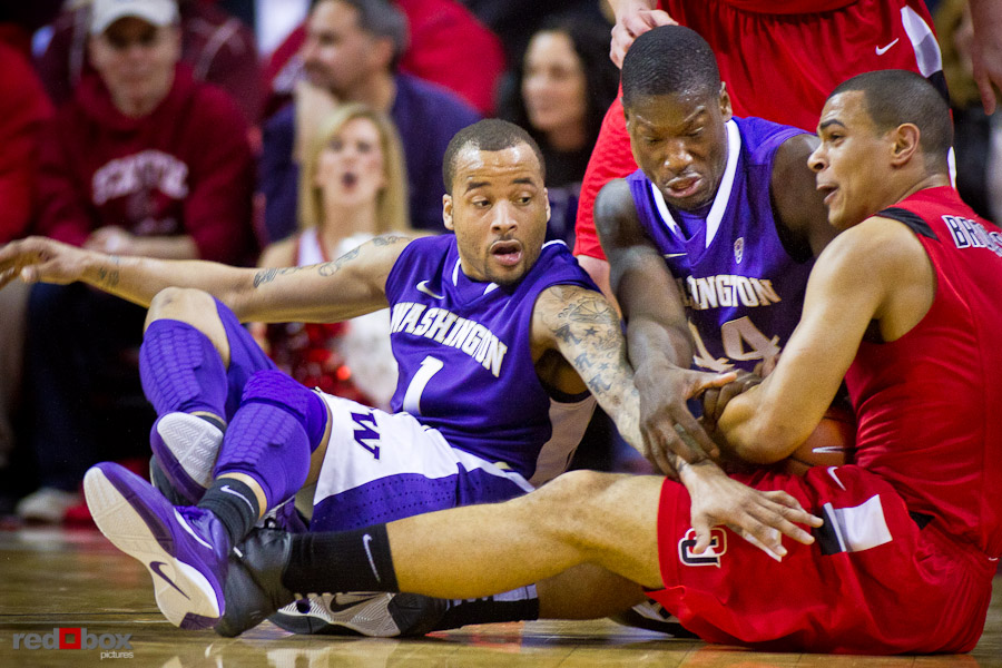 venoy-overton-darnell-gant-aaron-broussard The University of Washington Huskies Venoy Overton and Darnell Gant battle Seattle University Redhawks forward Aaron Broussard for the ball at Key Arena in Seattle Tuesday, Feb. 22, 2011. (Photo by Andy Rogers/Red Box Pictures)