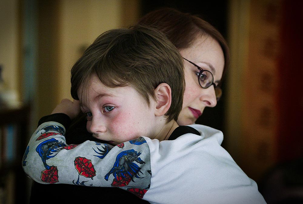 Sharky McGarry, who has autism, is comforted by his mother Lillie McGarry after he became upset. (Photographer: Dan DeLong)