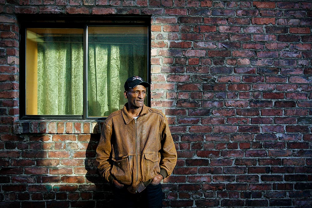 Oriyon Abraha, an Ethiopian refugee, stands near where he claims he was struck by a Seattle police officer, knocking out his teeth and slamming his head so hard he was rendered unconscious. (Photographer: Dan DeLong).