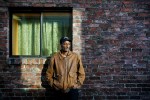 Oriyon Abraha, an Ethiopian refugee, stands near where he claims he was struck by a Seattle police officer, knocking out his teeth and slamming his head so hard he was rendered unconscious. (Photographer: Dan DeLong).