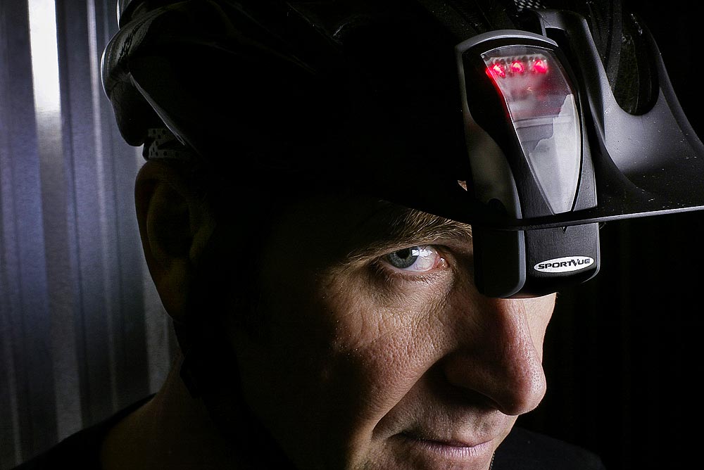 Dominic Dobson of Motion Research Corp. with a SportVue display, which alerts a cyclist and displays an I.D. for incoming cell phone calls. (Photographer: Andy Rogers)