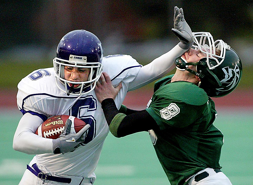 Edmonds-Woodway's Kyle Baeder didn't let a stiff-arm to the chops stop him from forcing Kamiak wide receiver Taylor Knowles out of bounds after a 6-yard reception. (Photographer: Scott Eklund)