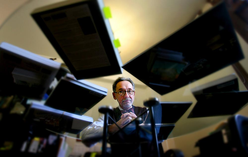 Walt Crowley, a Seattle historian and longtime political observer, shown with some his published books on local history. (Photographer: Scott Eklund)
